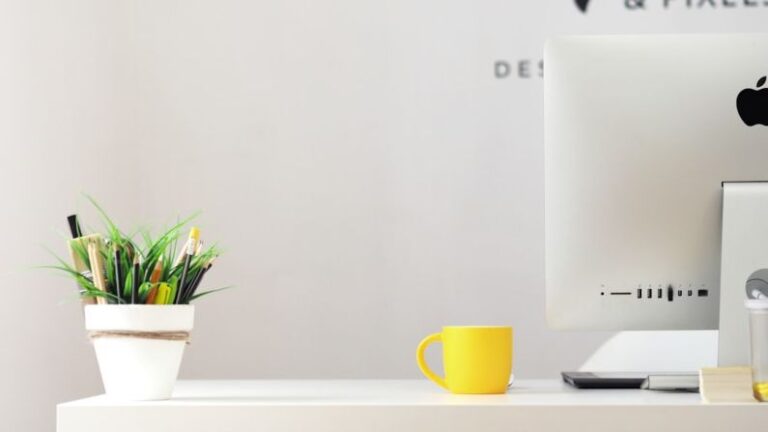 Smart Home Technology - yellow ceramic mug beside gray aluminum iMac