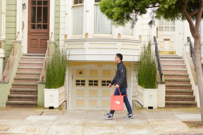 Neighborhood - man walking with DoorDash bag