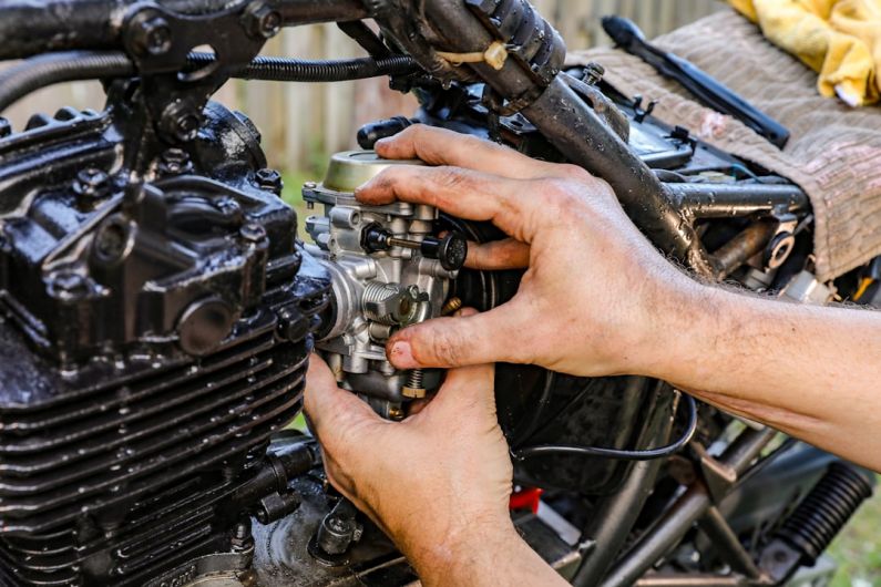 Minor Repairs - a person holding a car engine