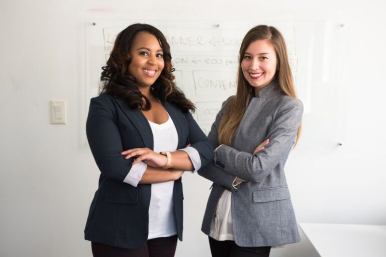 Property Manager - two women in suits standing beside wall